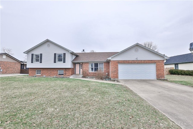 tri-level home with a garage, a front yard, brick siding, and driveway