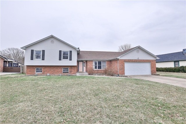 tri-level home with a garage, concrete driveway, brick siding, and a front lawn