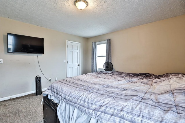 bedroom with carpet flooring, a textured ceiling, and baseboards