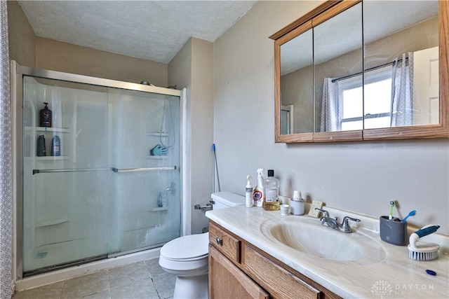 bathroom featuring a textured ceiling, tile patterned flooring, a shower stall, and toilet