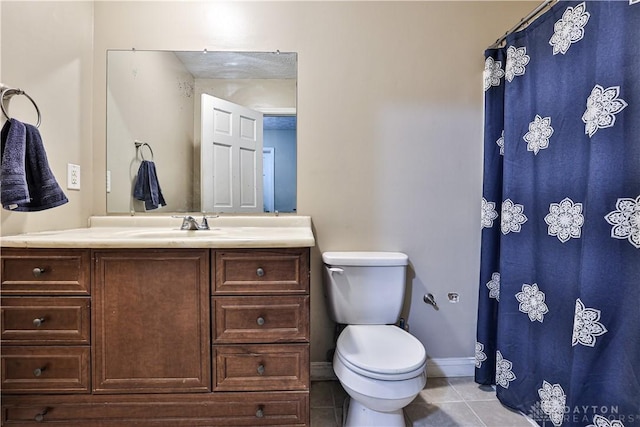 bathroom featuring curtained shower, toilet, vanity, tile patterned flooring, and baseboards