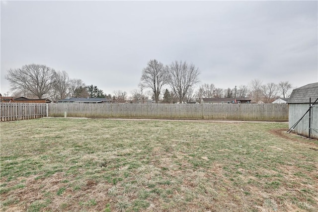 view of yard with an outbuilding and a fenced backyard