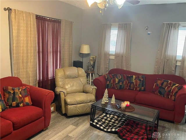 living room with ceiling fan and wood finished floors