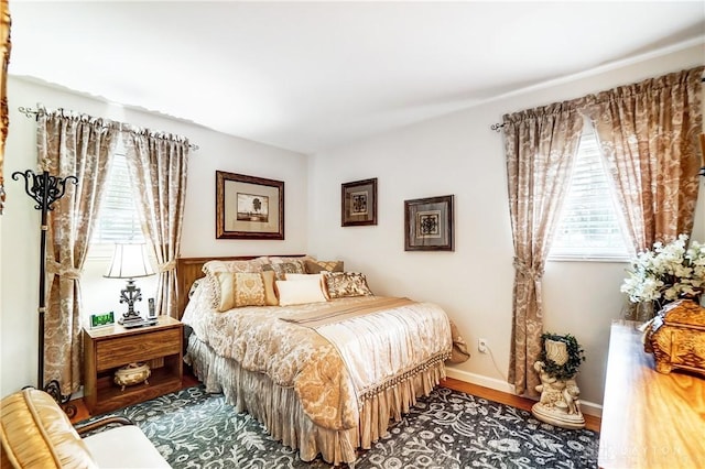 bedroom featuring baseboards and wood finished floors