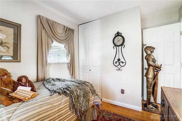 bedroom with wood finished floors and baseboards