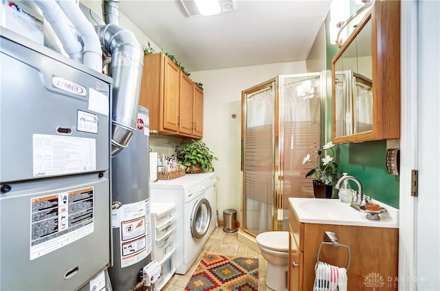 washroom featuring laundry area, a sink, water heater, heating unit, and washing machine and clothes dryer