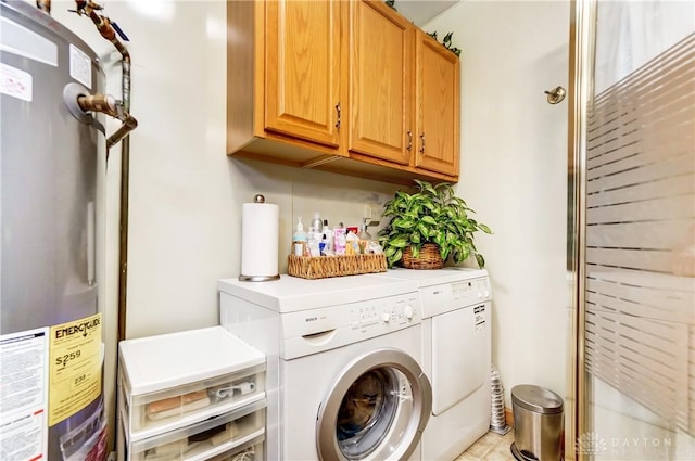 washroom with water heater, cabinet space, and washing machine and clothes dryer