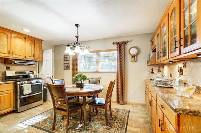 dining room with a chandelier and baseboards