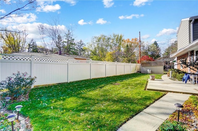 view of yard with a storage shed, a patio, an outdoor structure, and a fenced backyard