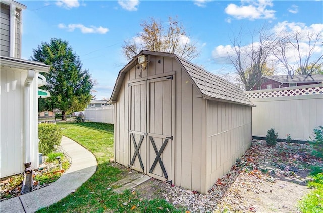 view of shed featuring fence