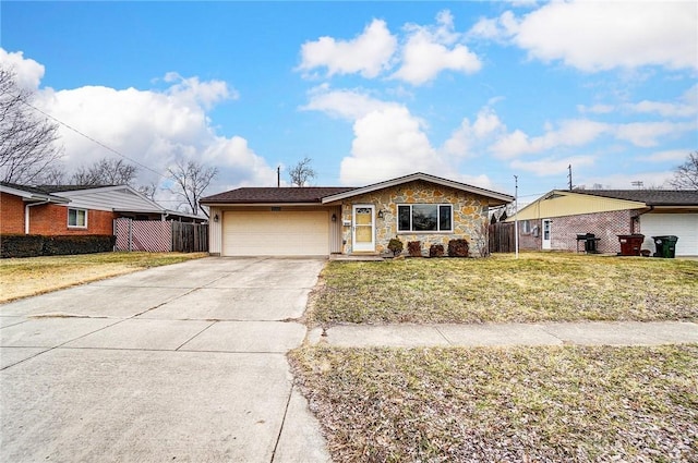 single story home with driveway, stone siding, an attached garage, fence, and a front yard