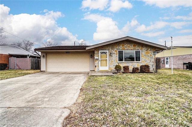 view of front of property featuring fence, a garage, stone siding, driveway, and a front lawn