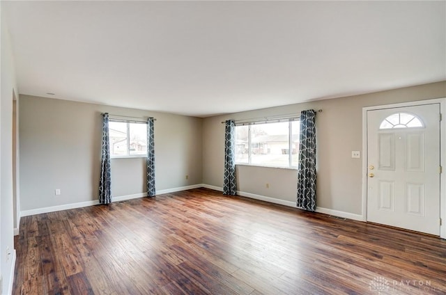 foyer with baseboards and wood finished floors