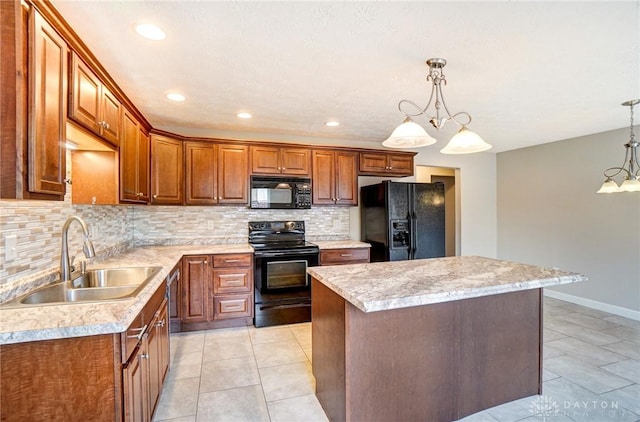 kitchen featuring a center island, tasteful backsplash, light countertops, a sink, and black appliances