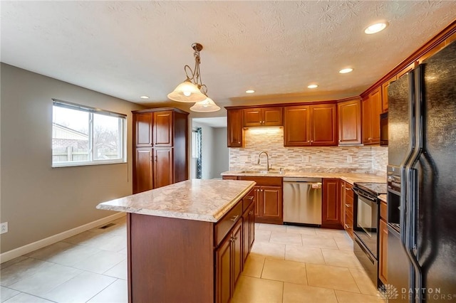 kitchen featuring a sink, light countertops, backsplash, a center island, and black appliances