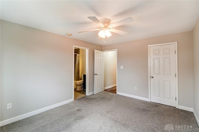 unfurnished bedroom featuring ensuite bath, ceiling fan, baseboards, and carpet flooring