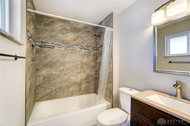 bathroom featuring vanity, toilet, and shower / bath combo with shower curtain