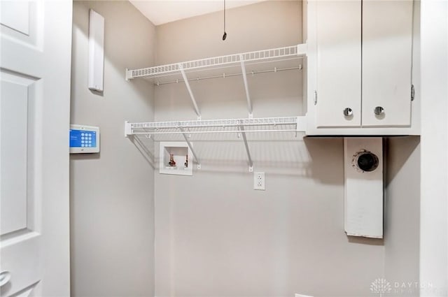 washroom with washer hookup and cabinet space