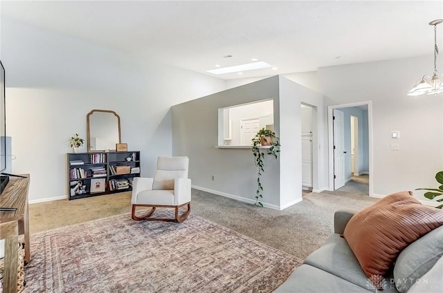 carpeted living room featuring baseboards, lofted ceiling, and a notable chandelier