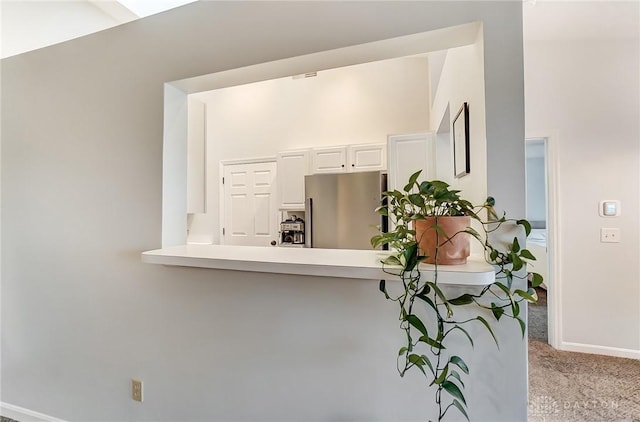 interior space featuring carpet and baseboards