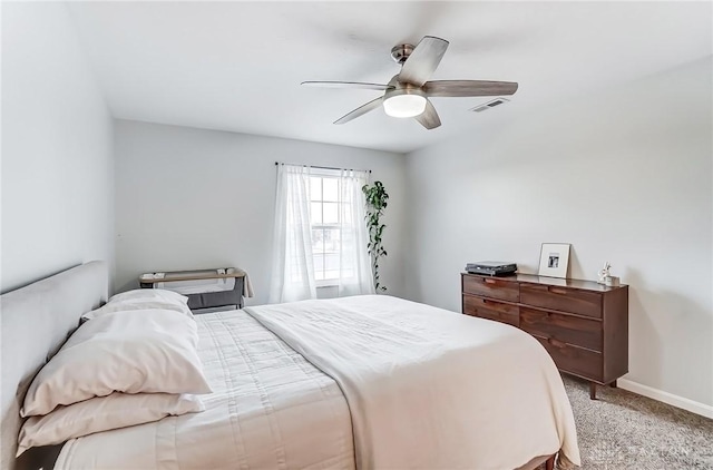 bedroom featuring a ceiling fan, carpet, visible vents, and baseboards