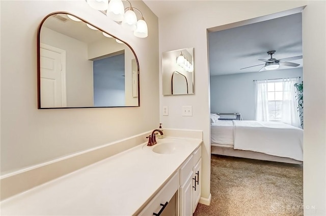 bathroom with vanity, a ceiling fan, and ensuite bathroom