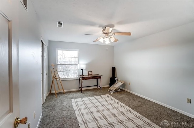 empty room featuring carpet floors, visible vents, ceiling fan, and baseboards