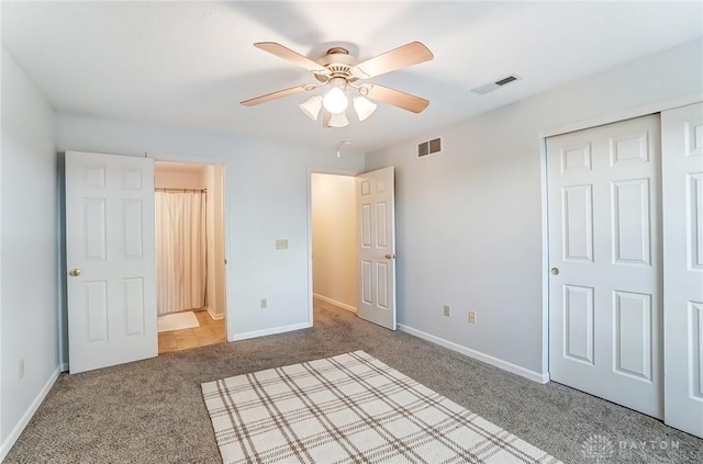 unfurnished bedroom with carpet floors, baseboards, and visible vents