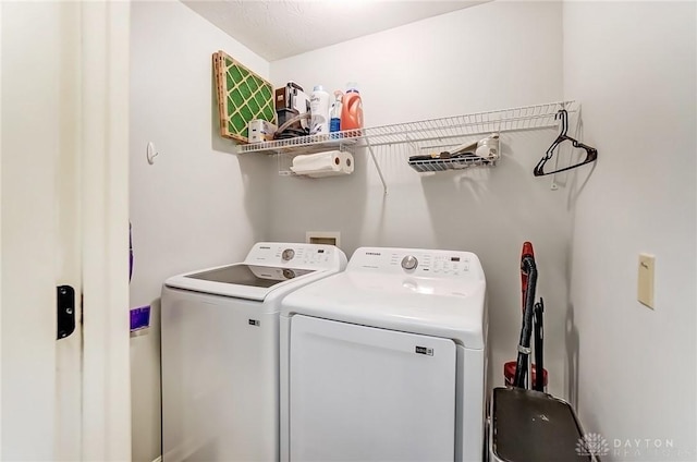 clothes washing area with washing machine and dryer and laundry area