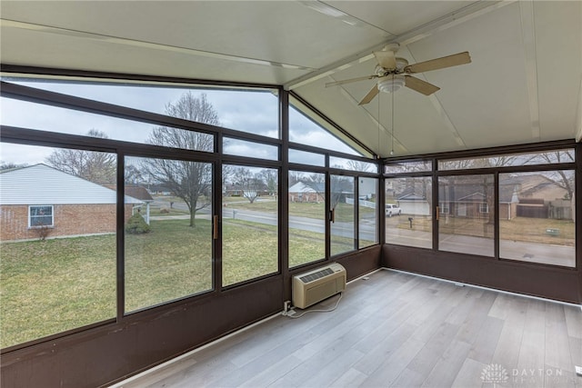 unfurnished sunroom with lofted ceiling with beams, a ceiling fan, and a wall mounted AC