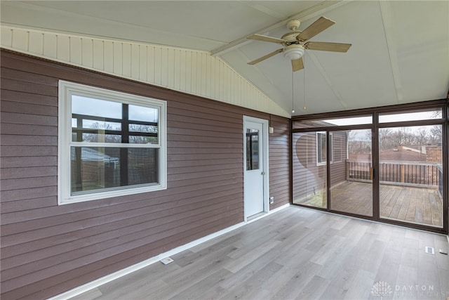 unfurnished sunroom with lofted ceiling and ceiling fan