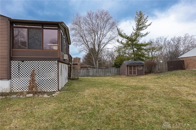 view of yard with fence private yard, a storage shed, a sunroom, and an outdoor structure