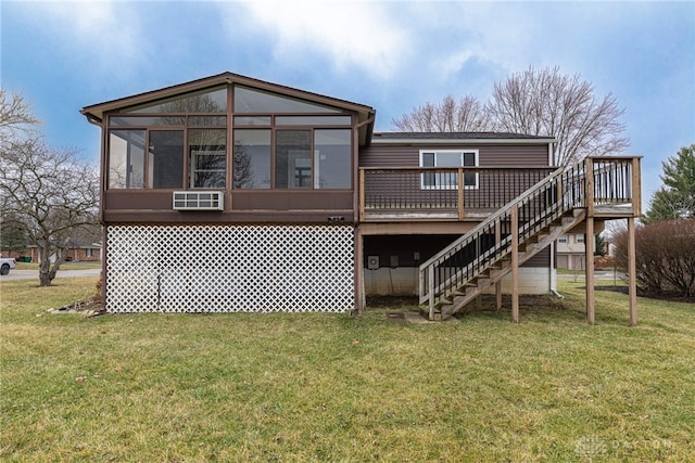 rear view of house with a deck, a yard, stairway, and a sunroom