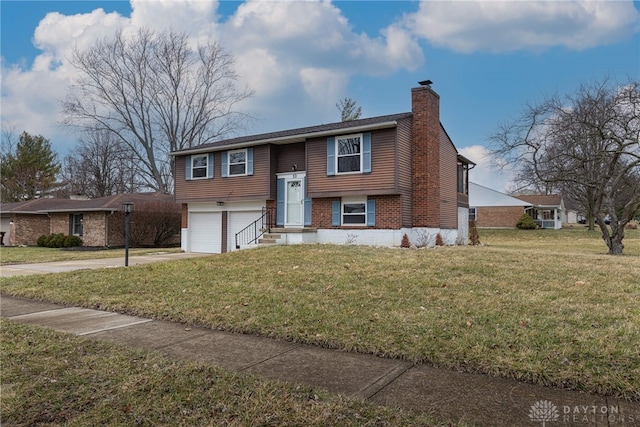 bi-level home featuring brick siding, a chimney, concrete driveway, and a front yard