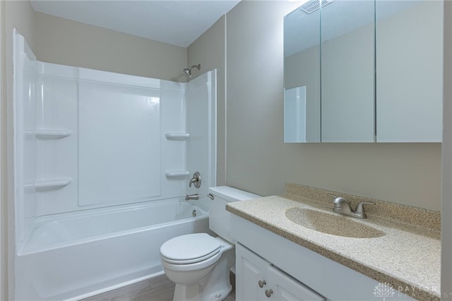 bathroom with toilet, wood finished floors, visible vents, vanity, and shower / washtub combination