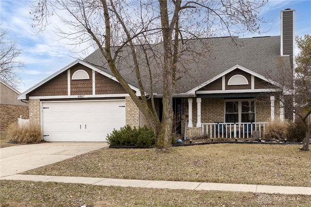 view of front of property with driveway, a chimney, an attached garage, covered porch, and brick siding