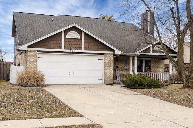 view of front facade with a garage, driveway, roof with shingles, covered porch, and brick siding