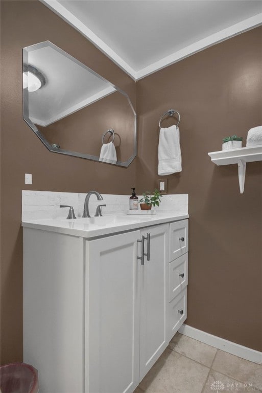 bathroom with vanity, baseboards, and tile patterned floors