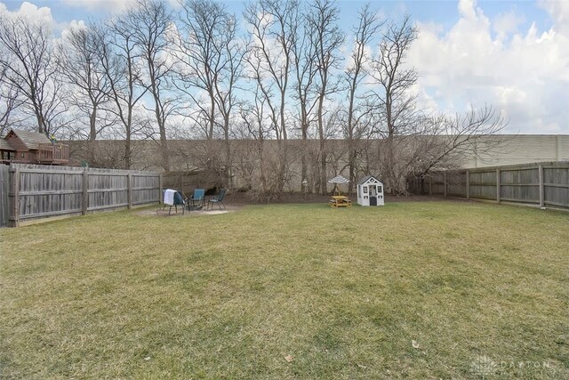 view of yard featuring a fenced backyard and an outbuilding