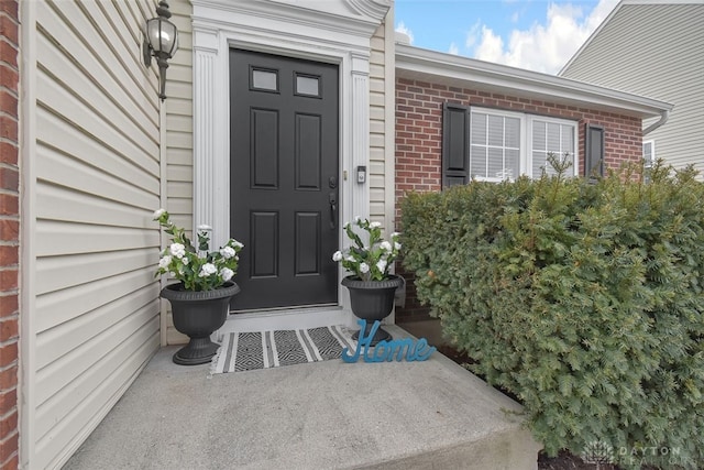 property entrance with brick siding