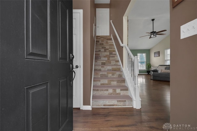 entrance foyer with baseboards, lofted ceiling, ceiling fan, stairway, and wood finished floors