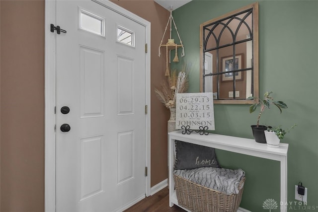 entryway featuring dark wood-type flooring and baseboards