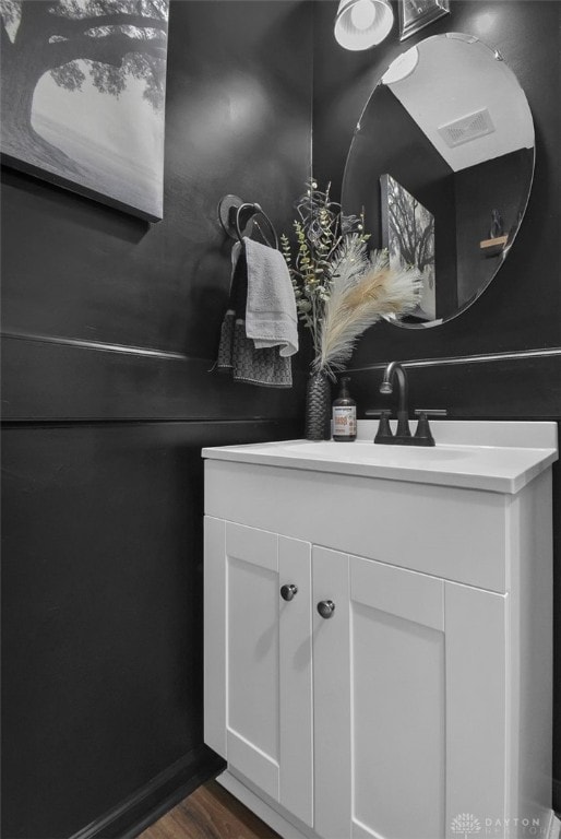 bathroom with wood finished floors and vanity