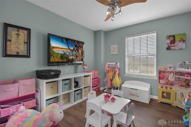 game room featuring a ceiling fan, baseboards, and wood finished floors