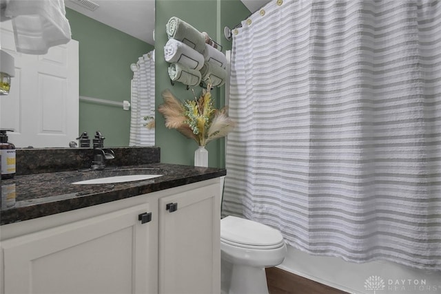 bathroom featuring vanity, toilet, and a shower with curtain