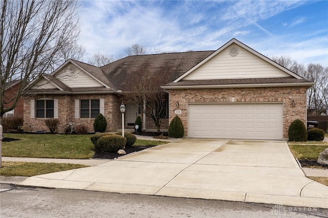 single story home with brick siding, a shingled roof, concrete driveway, an attached garage, and a front yard