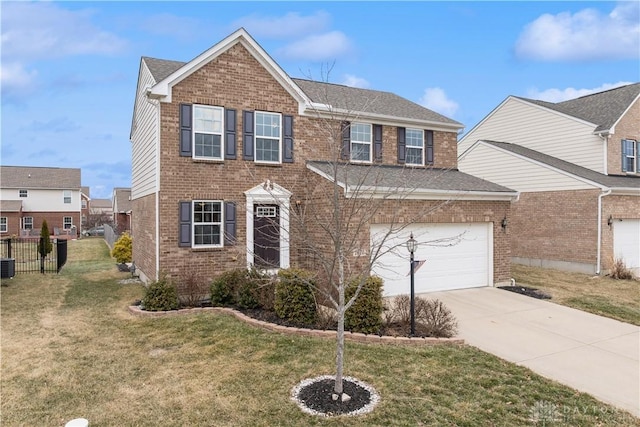 view of front of home with brick siding, driveway, a front lawn, and fence