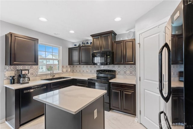 kitchen featuring marble finish floor, light countertops, a sink, and black appliances