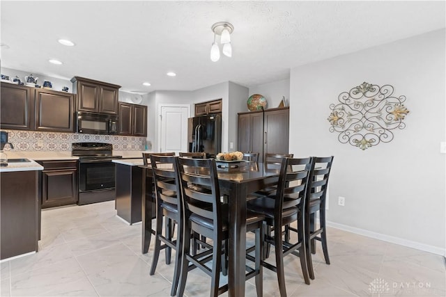 dining area with recessed lighting, marble finish floor, and baseboards