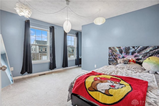 bedroom with carpet, visible vents, and baseboards